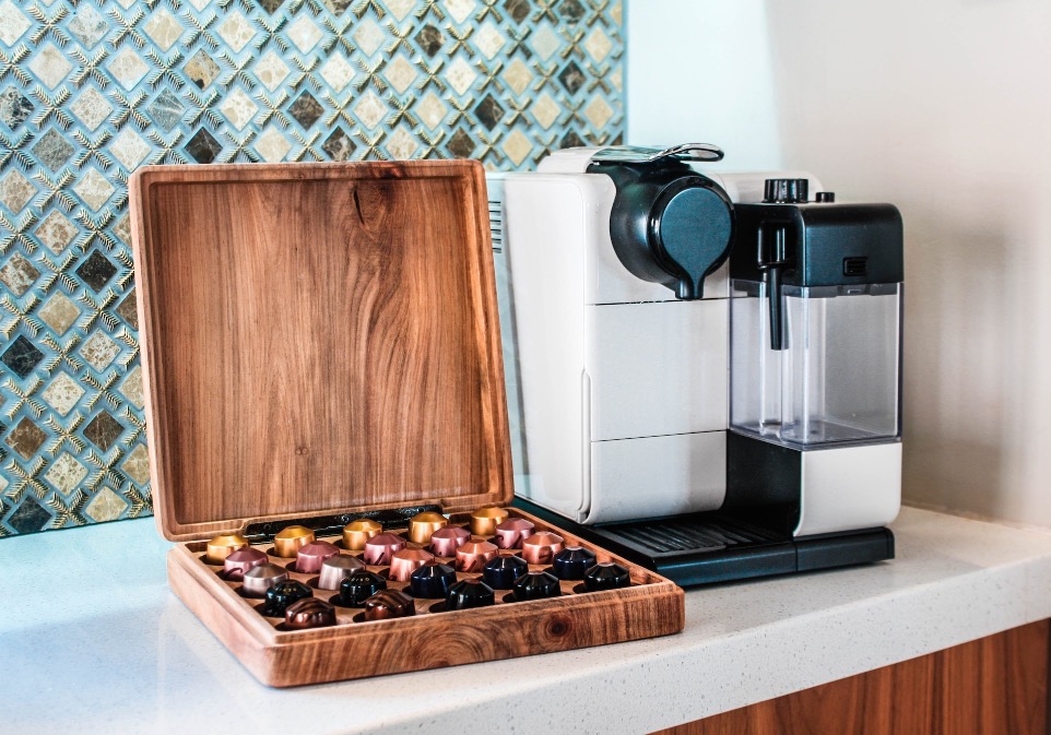 a coffee maker sitting on top of a counter next to a wooden box